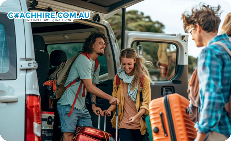 Group of friends loading luggage into a mini bus for an Australian road trip adventure.